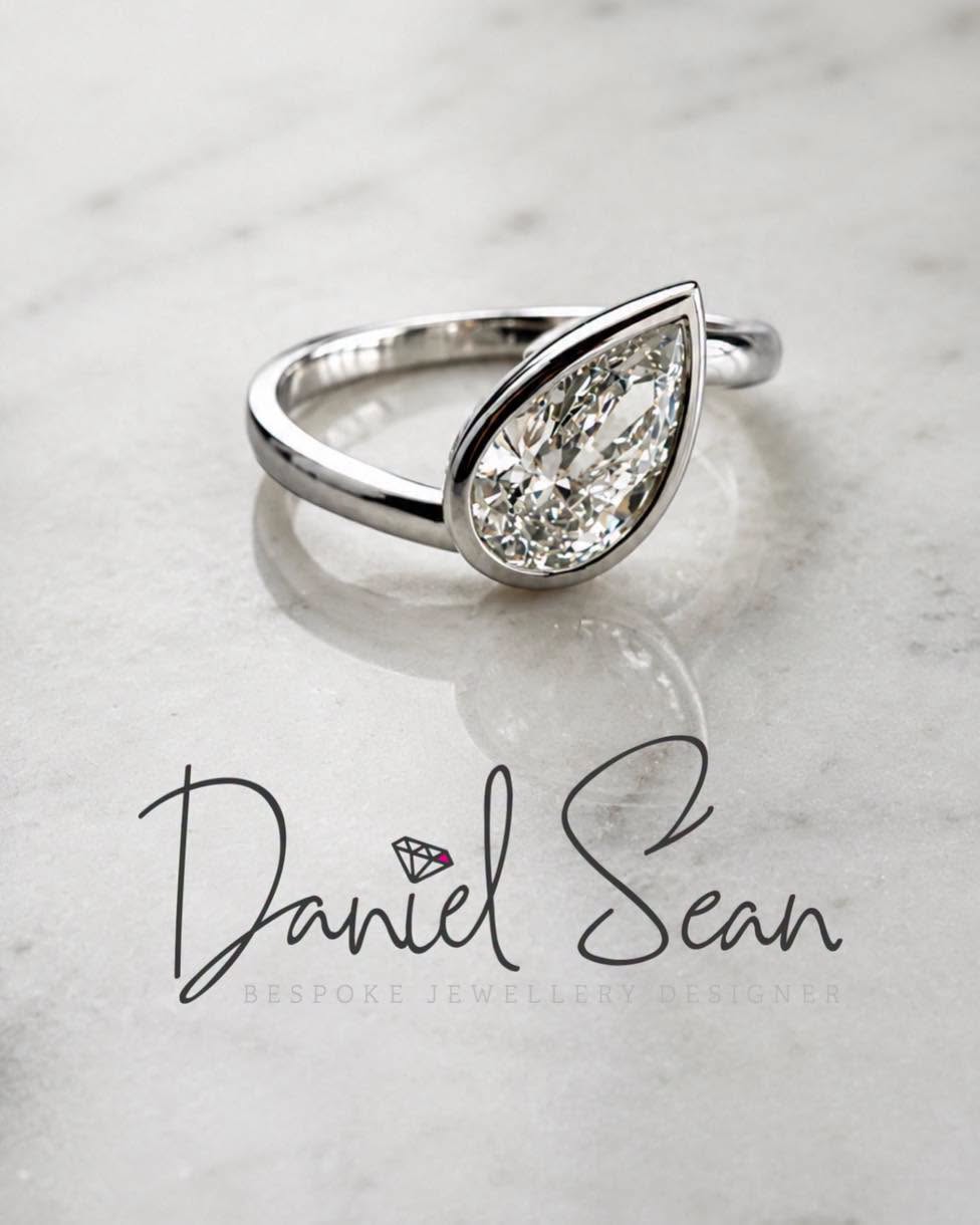 Pear-shaped diamond ring on marble